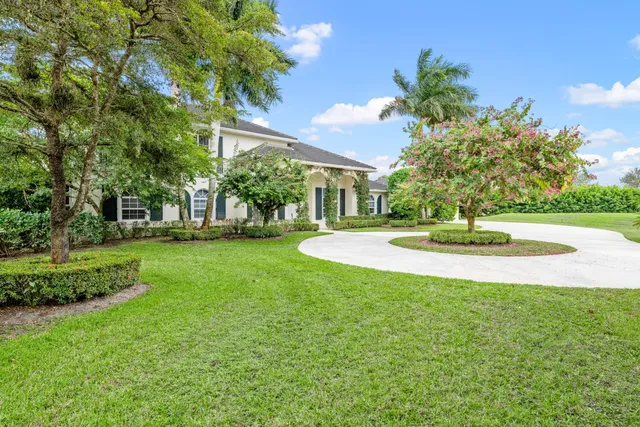 a living room with furniture a fireplace and a chandelier
