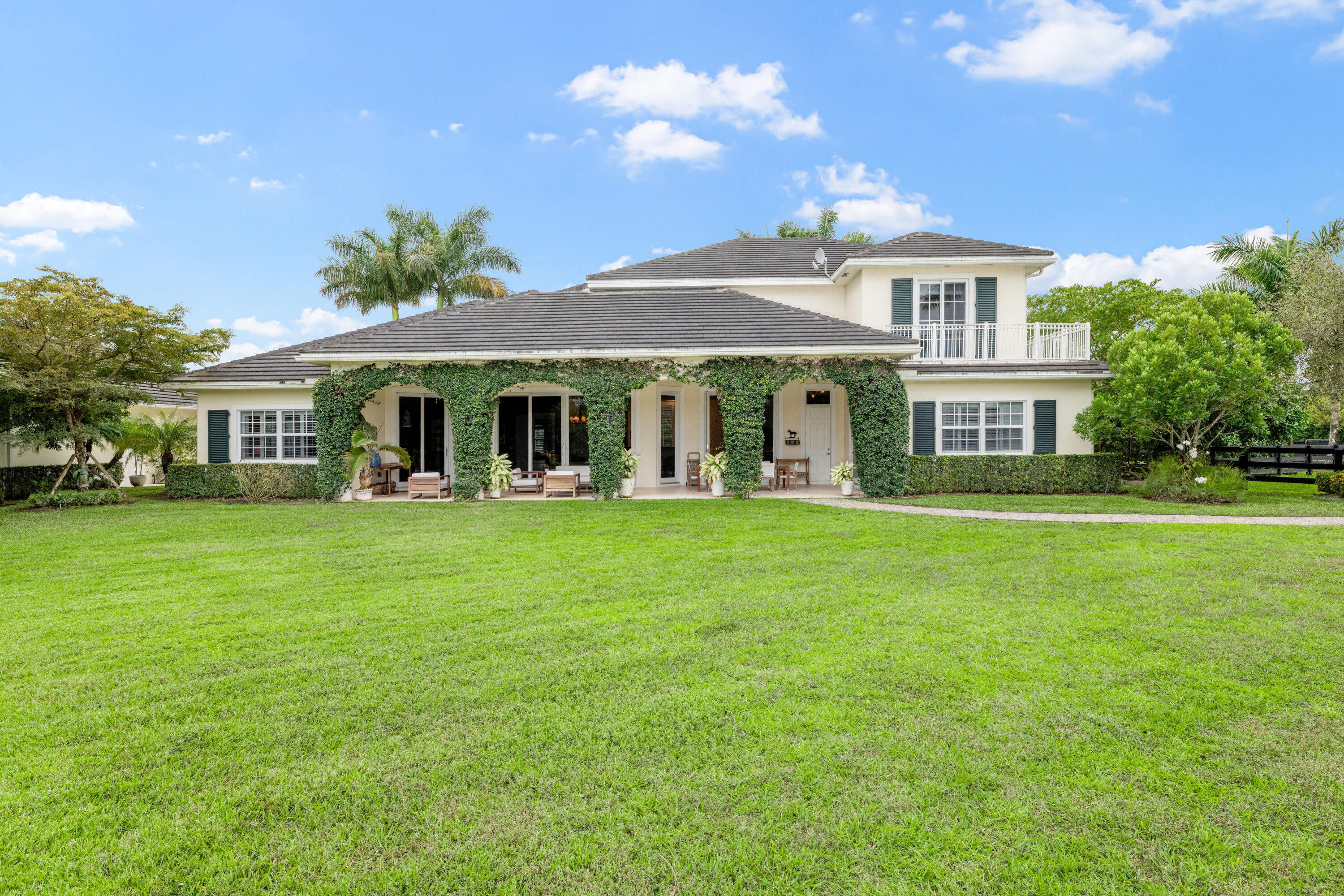 14739 Jumper Road Wellington, FL 33449 - Photo 21 of 124 a front view of a house with a garden