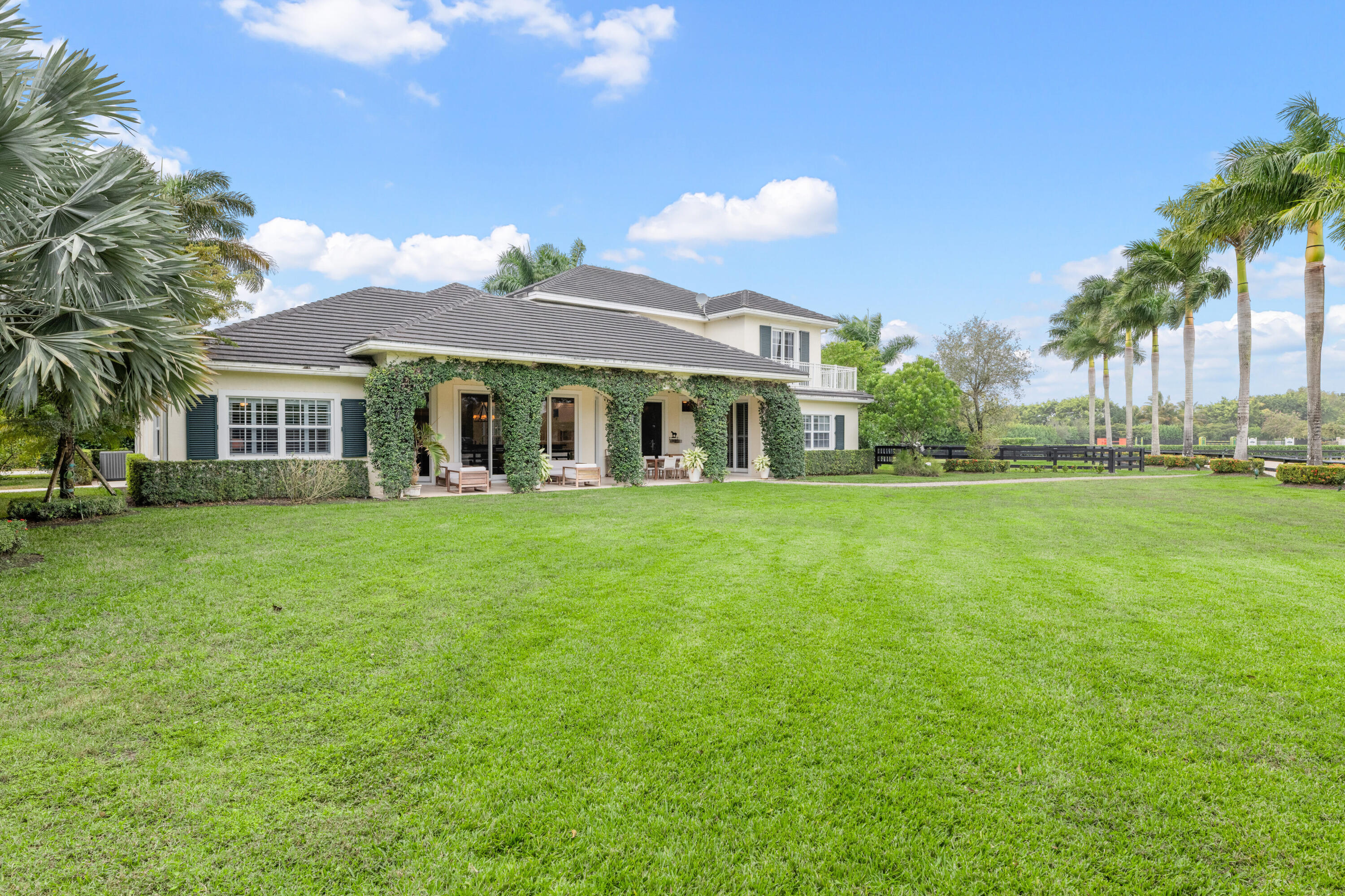 14739 Jumper Road Wellington, FL 33449 - Photo 22 of 124 a front view of a house with a yard