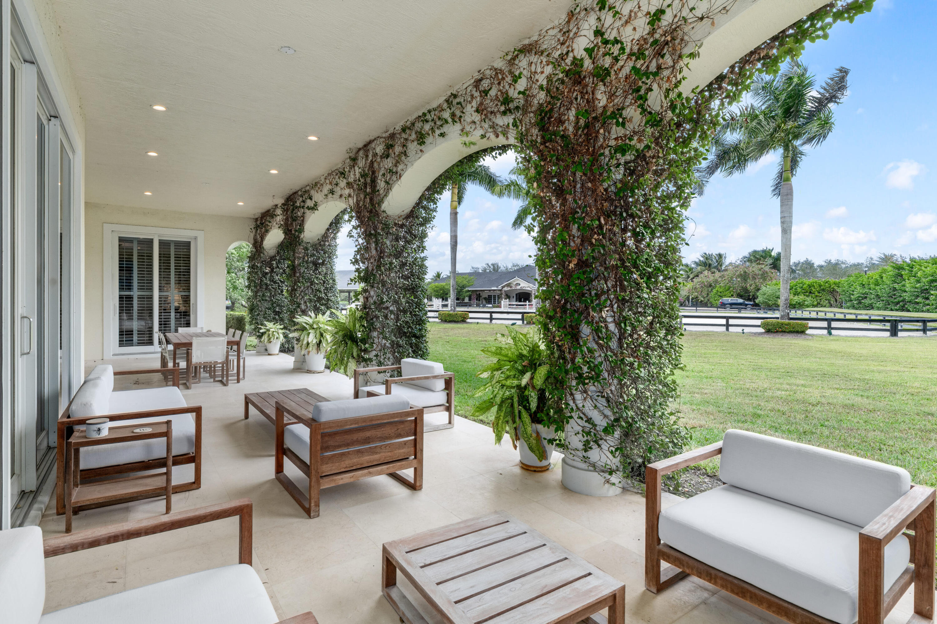 14739 Jumper Road Wellington, FL 33449 - Photo 23 of 124 a living room with patio furniture and a garden
