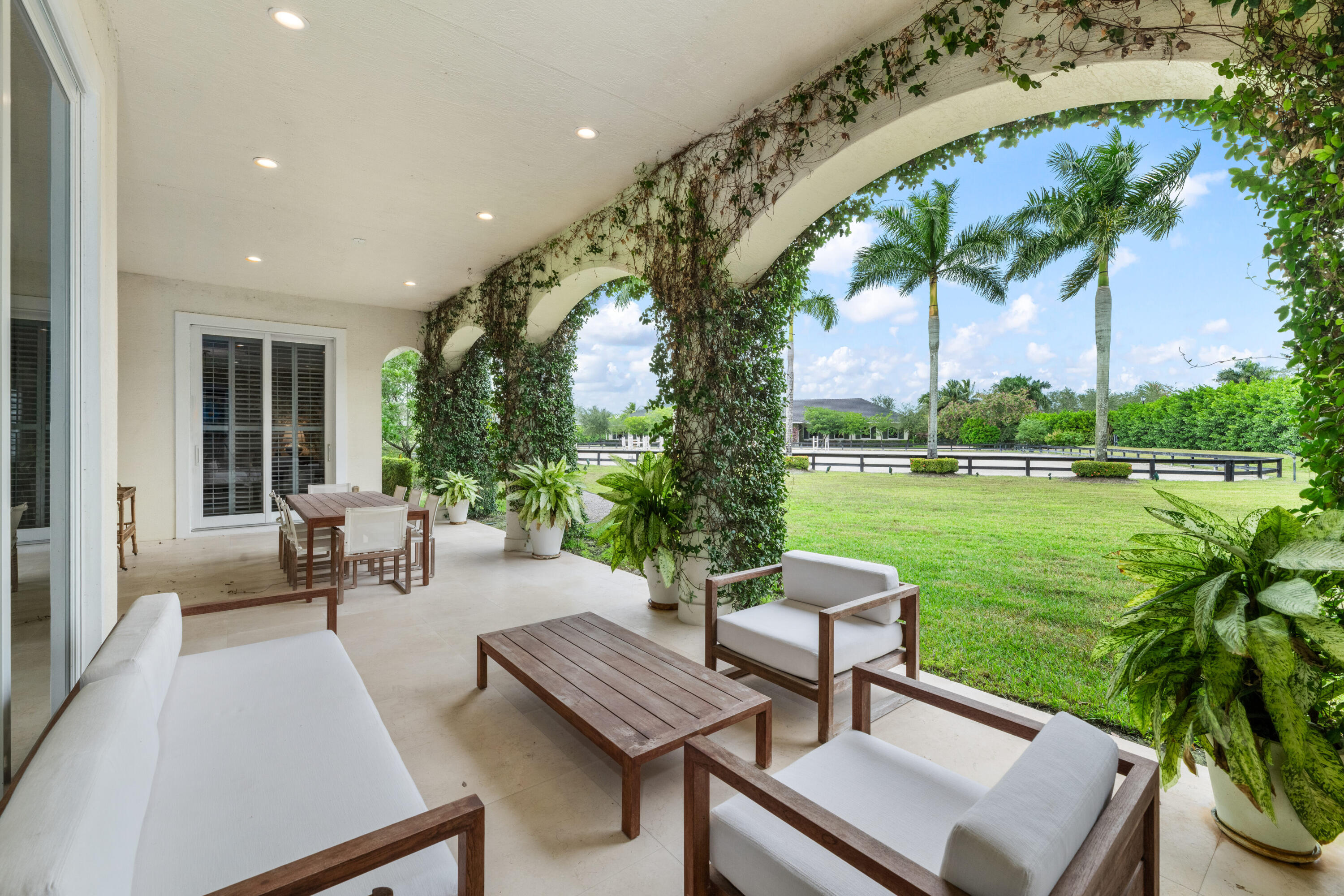 14739 Jumper Road Wellington, FL 33449 - Photo 24 of 124 a view of a swimming pool with a patio and a garden