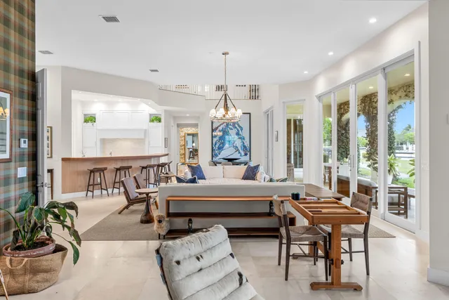 a view of a house with a yard and potted plants