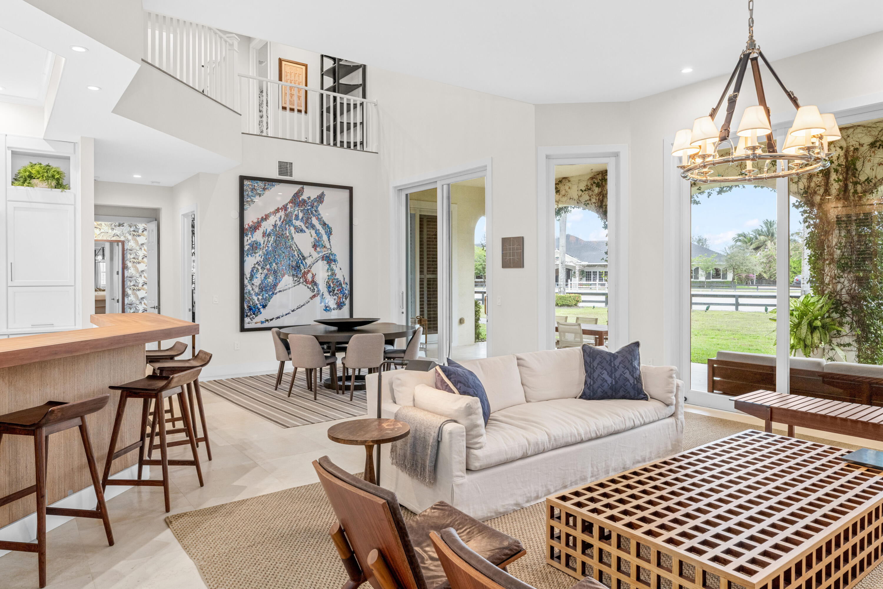 14739 Jumper Road Wellington, FL 33449 - Photo 41 of 124 a living room with furniture a fireplace and a chandelier