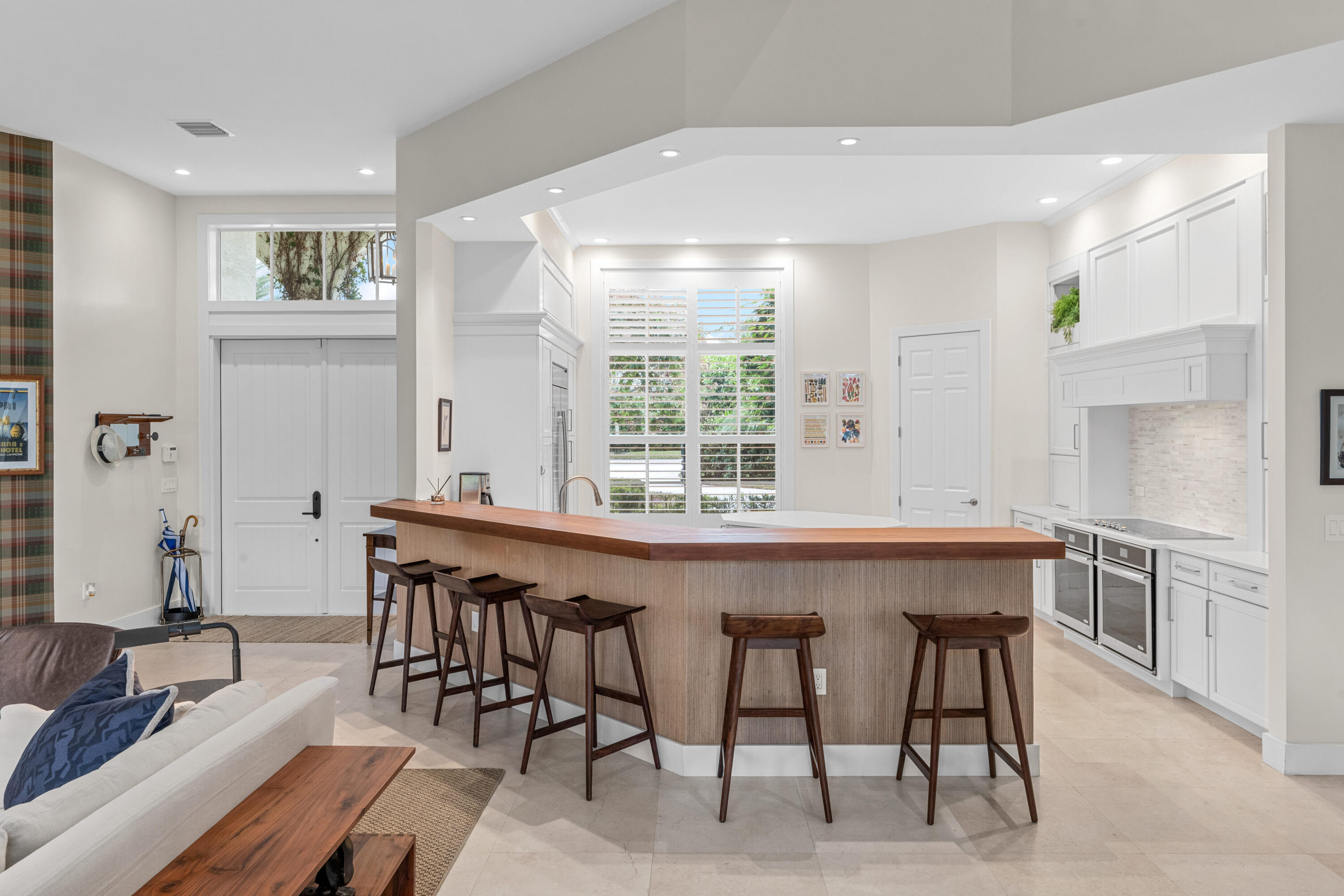 14739 Jumper Road Wellington, FL 33449 - Photo 42 of 124 a dining hall with stainless steel appliances granite countertop a kitchen island and chairs in it