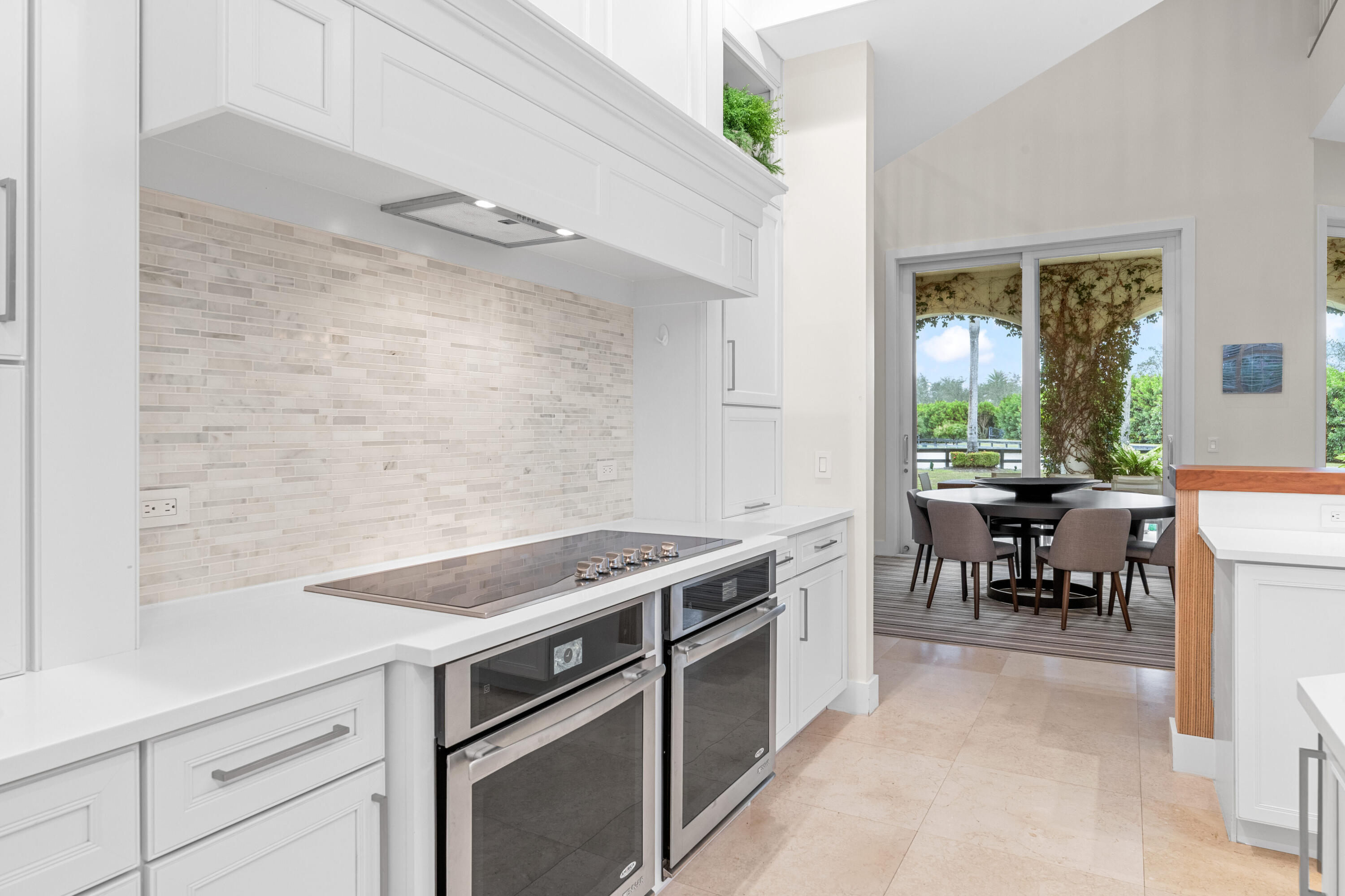 14739 Jumper Road Wellington, FL 33449 - Photo 46 of 124 a kitchen with a stove and a table