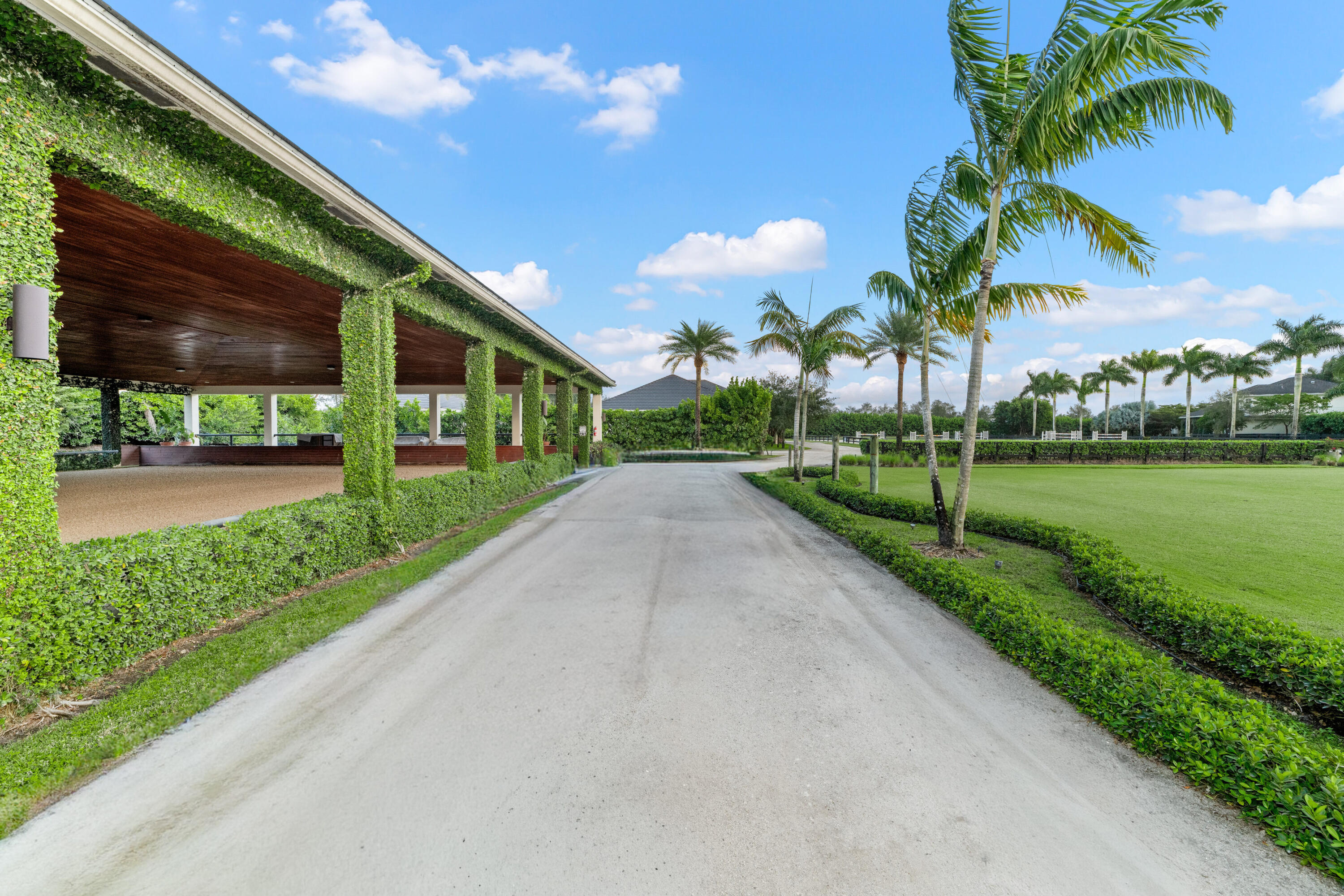 14739 Jumper Road Wellington, FL 33449 - Photo 83 of 124 a view of a house with a yard and potted plants