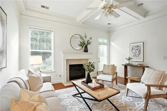 a living room with furniture a fireplace and a table