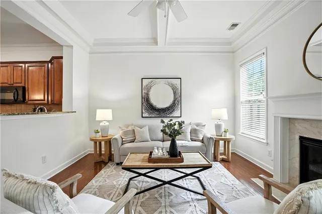 a living room with furniture a clock and a fireplace