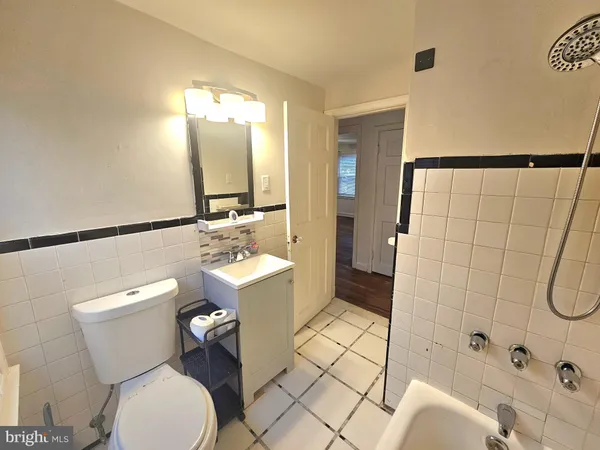 a bathroom with a toilet sink shower and mirror