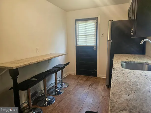 a kitchen with a wooden floor and furniture