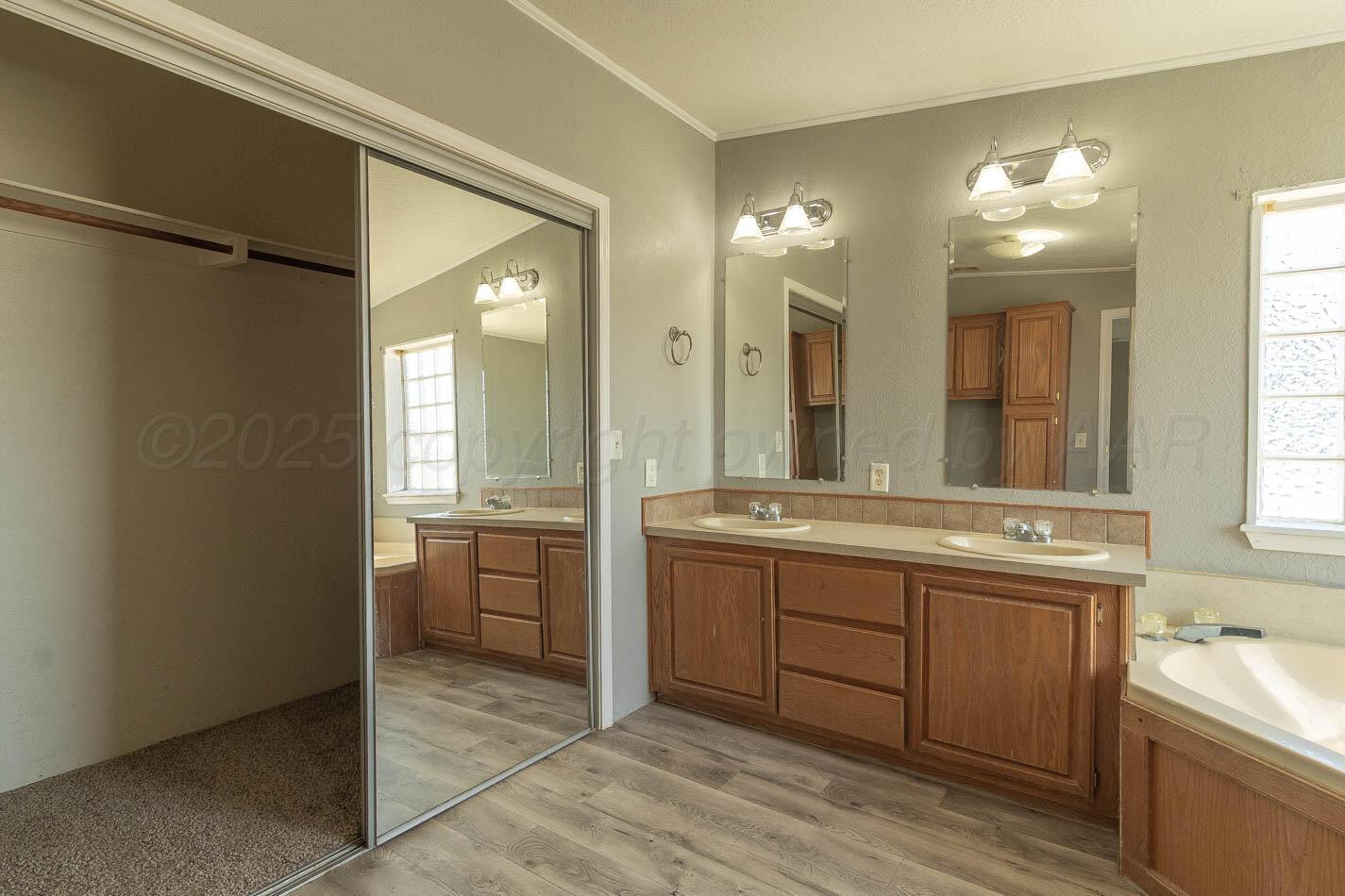 5606 West McCormick Road Amarillo, TX 79118 - Photo 12 of 23 a spacious bathroom with a granite countertop sink a toilet and a mirror