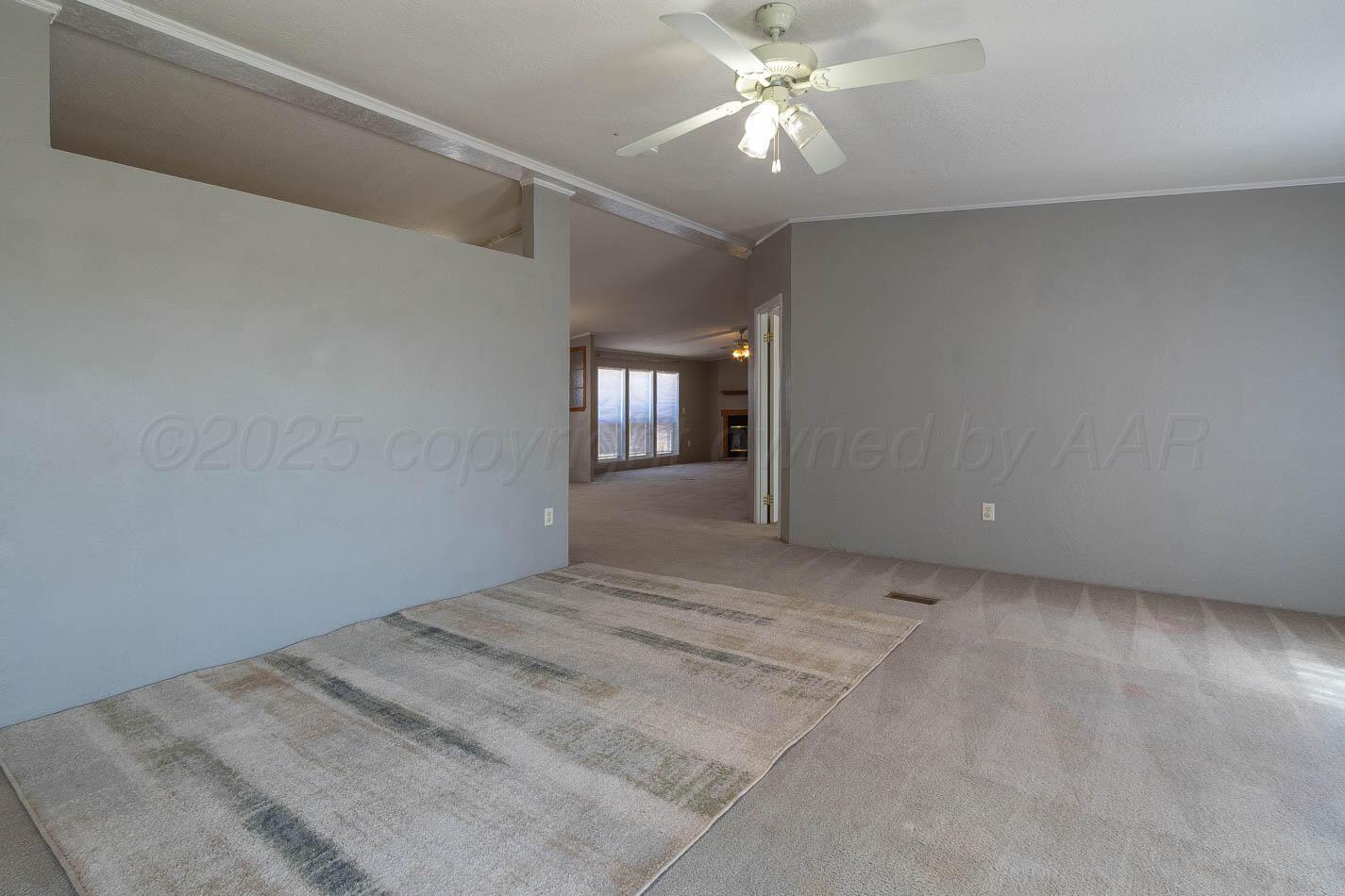 5606 West McCormick Road Amarillo, TX 79118 - Photo 3 of 23 a view of a livingroom with a ceiling fan and window