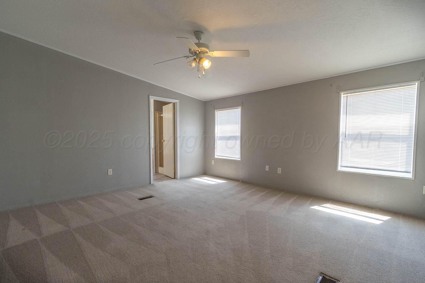 5606 West McCormick Road Amarillo, TX 79118 - Photo 10 of 23 a view of an empty room with a window