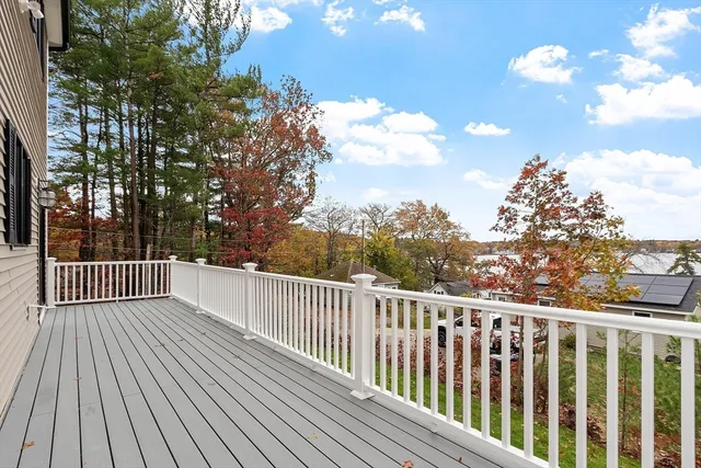 a view of balcony with wooden floor and fence