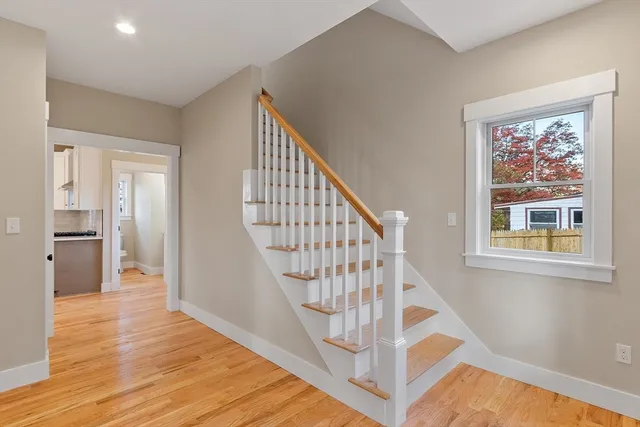 a view of an entryway with wooden floor and door