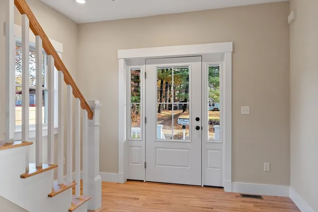 a view of empty room with wooden floor and fireplace