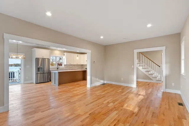 an empty room with windows and fireplace