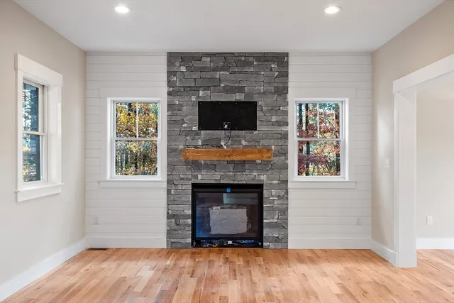 a view of a kitchen with wooden floor electronic appliances and windows