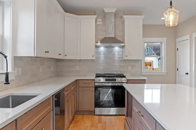 a bathroom with a window sink and cabinets