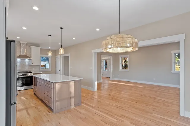 a bathroom with a toilet sink a mirror and vanity