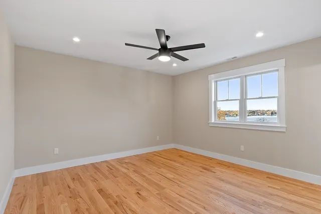 a view of a livingroom with a ceiling fan and wooden floor