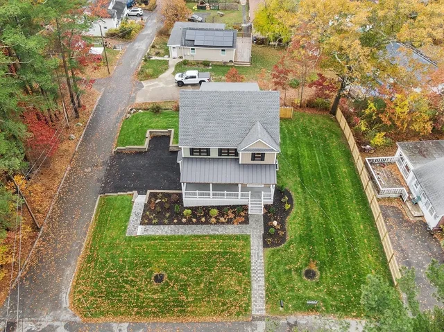 an aerial view of a house with a yard