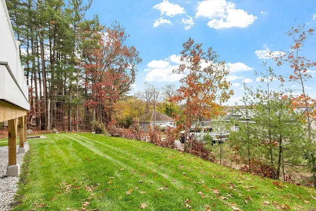 a balcony with wooden floor and trees