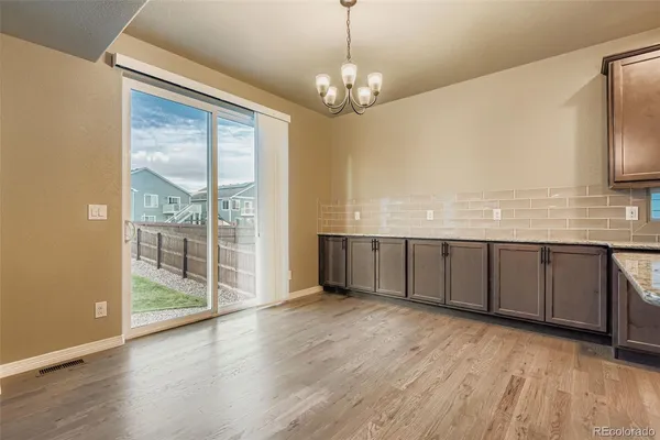a view of a room with wooden floor and large windows