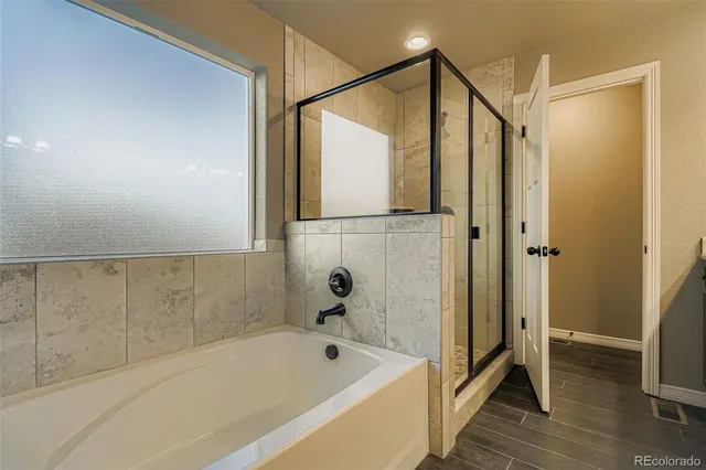 a bathroom with a bathtub and a shower
