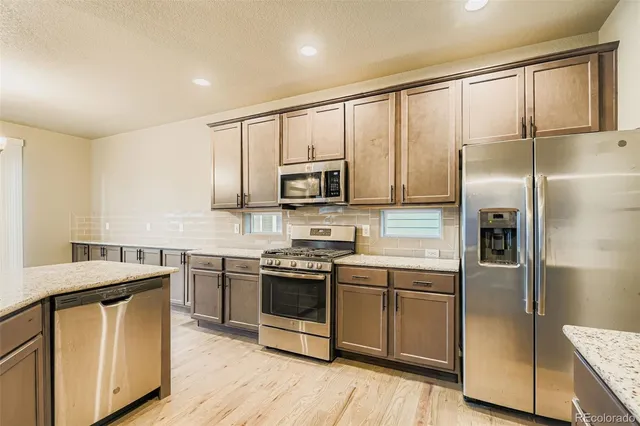 a kitchen with a sink stainless steel appliances and cabinets