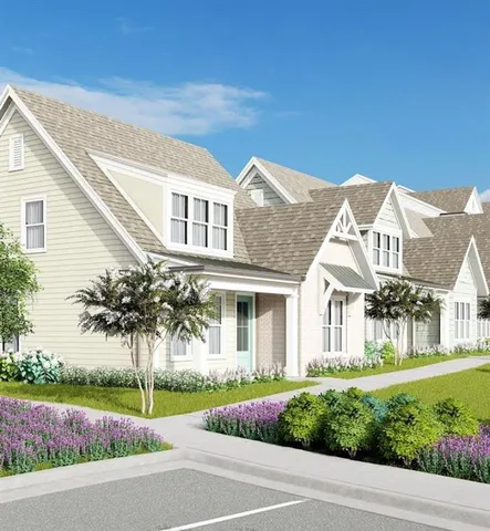 a front view of a house with a garden and plants