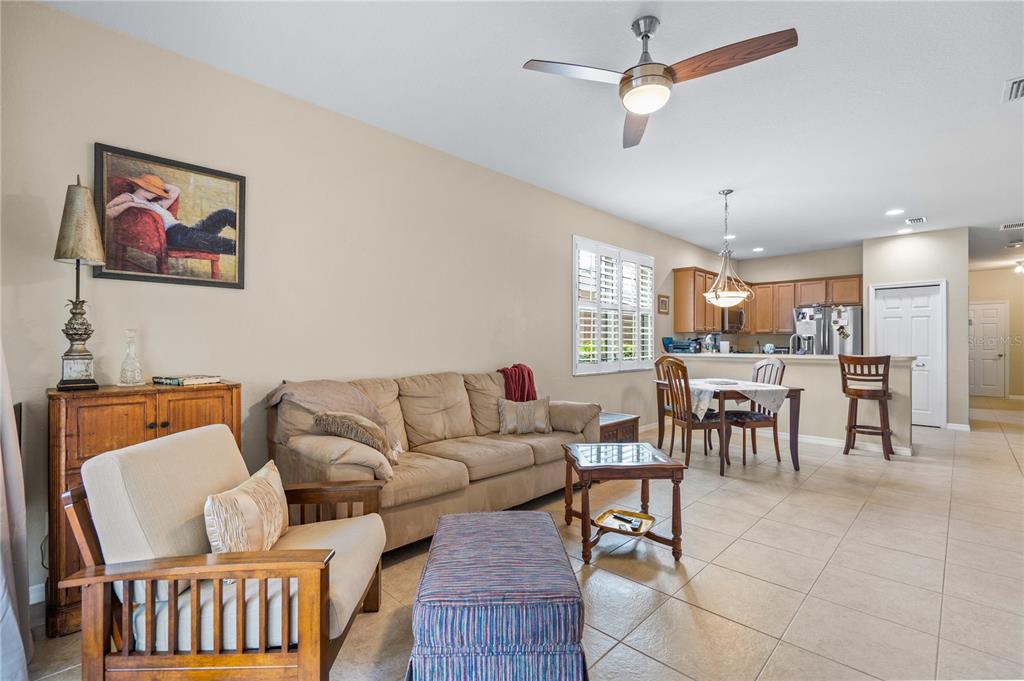 11815 Tempest Harbor Loop Venice, FL 34292 - Photo 11 of 63 a living room with furniture kitchen view and a window
