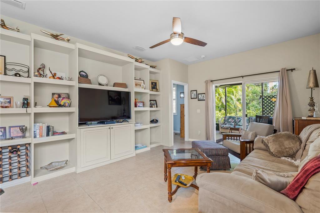 11815 Tempest Harbor Loop Venice, FL 34292 - Photo 13 of 63 a living room with furniture and a flat screen tv