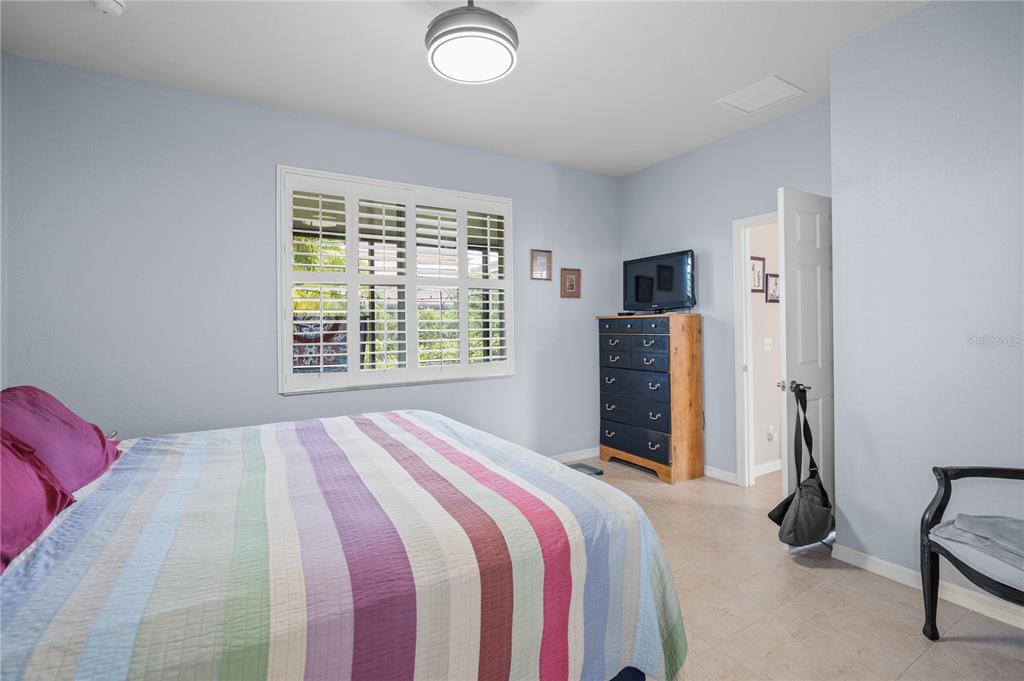 11815 Tempest Harbor Loop Venice, FL 34292 - Photo 17 of 63 a bedroom with a bed and a television