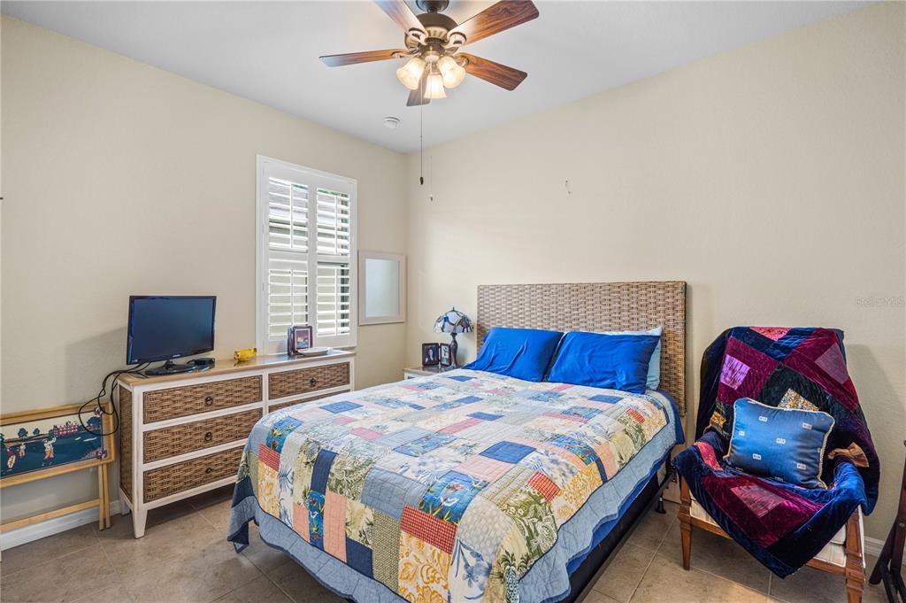 11815 Tempest Harbor Loop Venice, FL 34292 - Photo 21 of 63 a bedroom with a bed and a chandelier