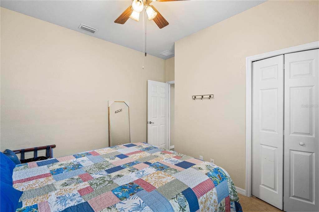11815 Tempest Harbor Loop Venice, FL 34292 - Photo 23 of 63 a bedroom with a bed and a chandelier