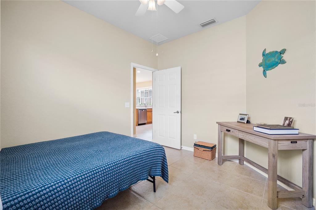 11815 Tempest Harbor Loop Venice, FL 34292 - Photo 24 of 63 a bedroom with a bed and a table in it