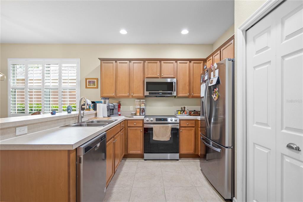 11815 Tempest Harbor Loop Venice, FL 34292 - Photo 5 of 63 a kitchen with stainless steel appliances granite countertop a sink stove refrigerator and cabinets