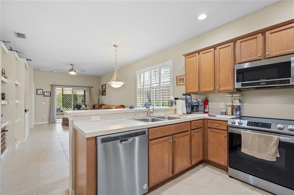 11815 Tempest Harbor Loop Venice, FL 34292 - Photo 6 of 63 a kitchen with a sink stove and microwave