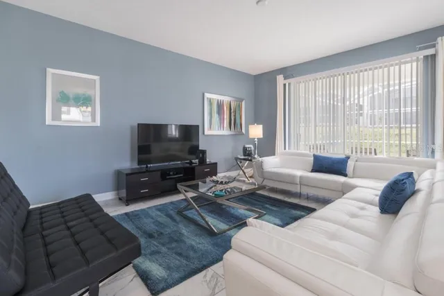 a living room with furniture and a flat screen tv