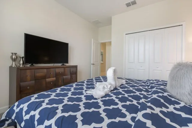 a bedroom with a bed and a flat screen tv
