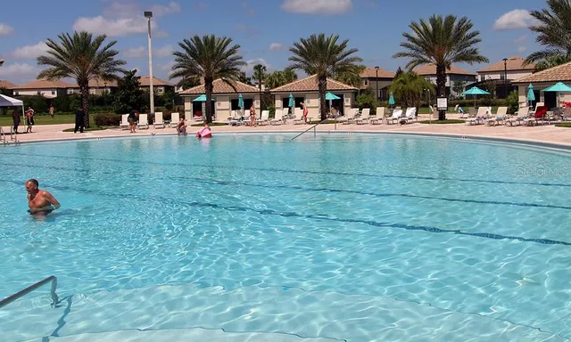 a view of multiple houses with yard and porch