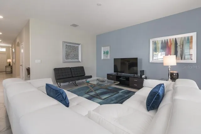 a bedroom with bed and a flat screen tv