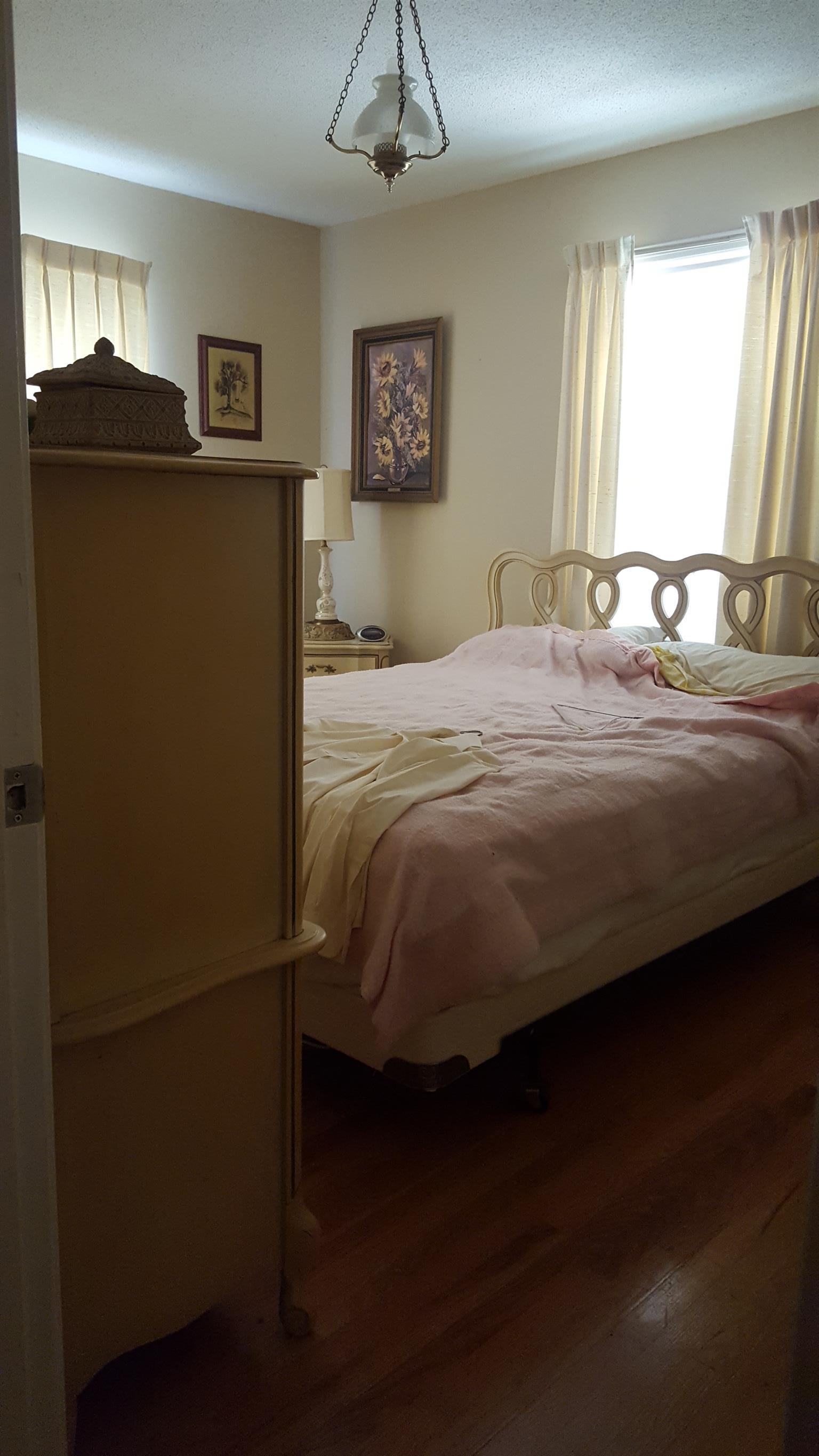 2760 Old Laguardo Road East Lebanon, TN 37087 - Photo 20 of 30 a bedroom with a bed and a chandelier