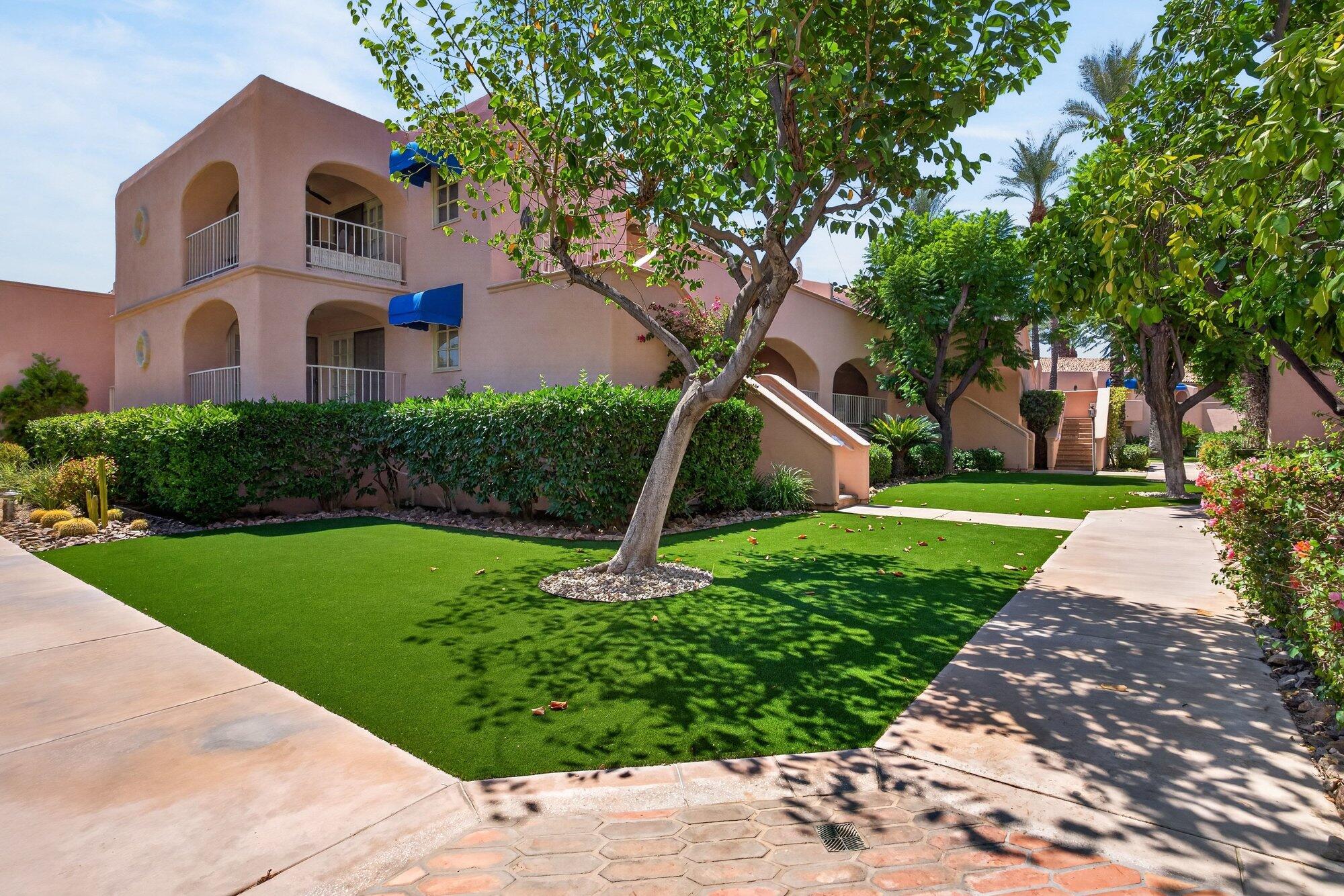 500 East Amado Road, Unit 313 Palm Springs, CA 92262 - Photo 2 of 32 a front view of a house with a yard