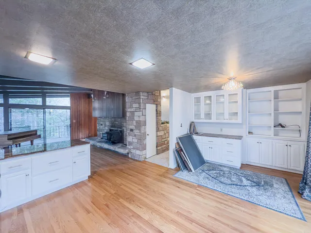 a large room with wooden floor and furniture