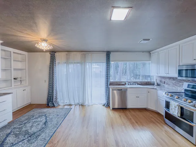 a kitchen with granite countertop wooden cabinets a sink and dishwasher