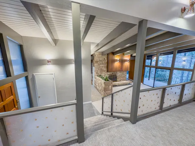 a view of hallway with stairs and wooden floor