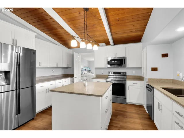 a kitchen with a sink a stove a microwave and refrigerator