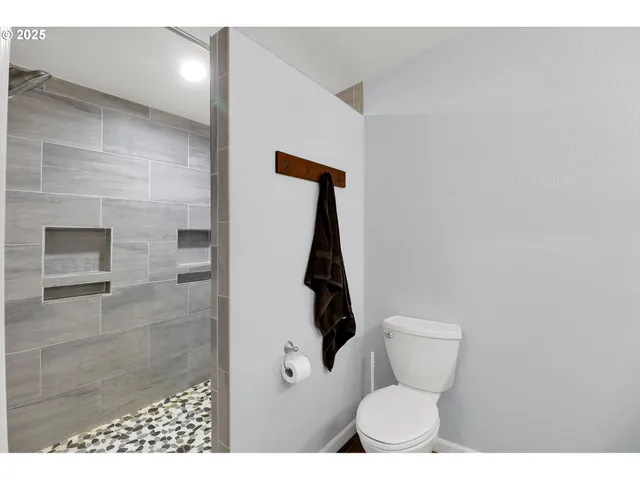 a bathroom with a toilet and a shower